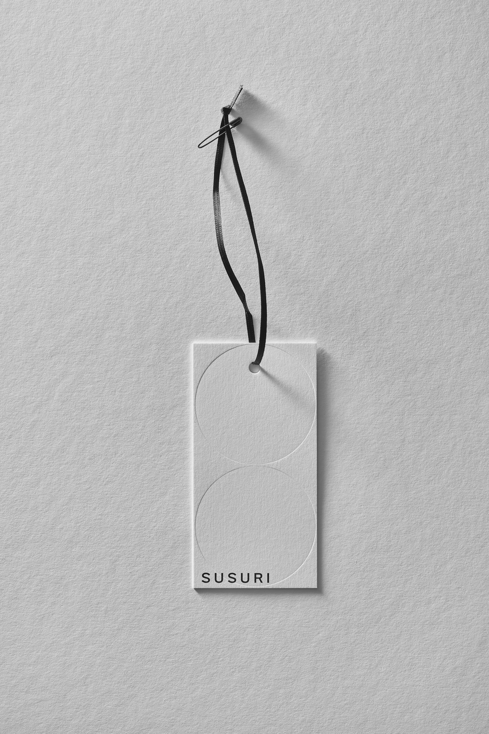 SUSURI paper cloth tag with blind embossed double circles